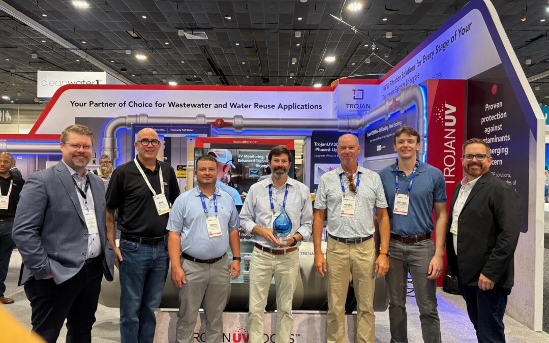 Southern Sales team members with TrojanUV representatives and the Excellence Award at WEFTEC 2026.